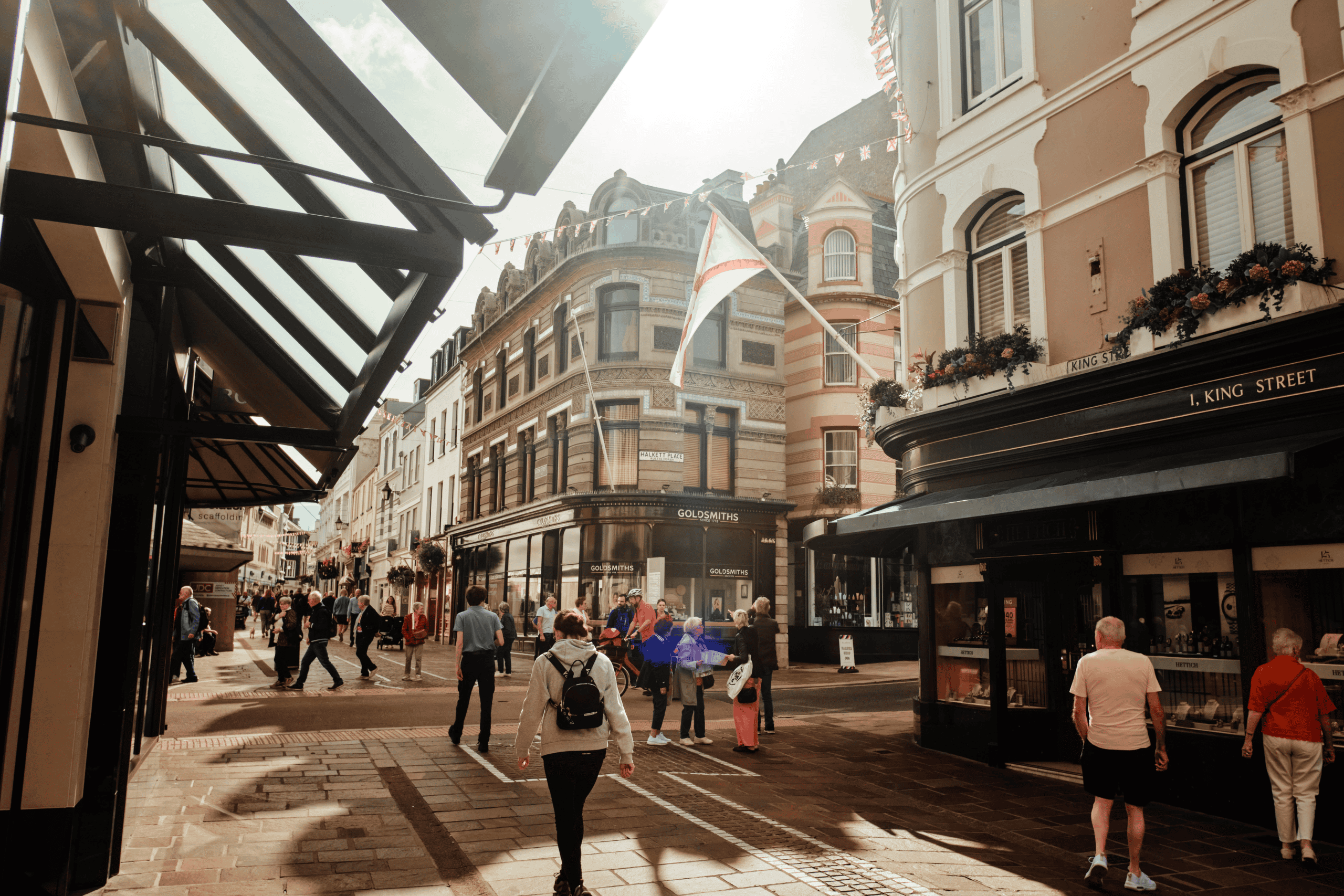 An urban shopping district with busy pedestrians, historic buildings, and outdoor cafes in a lively.